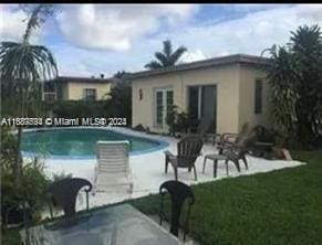 view of pool with a patio area and a yard