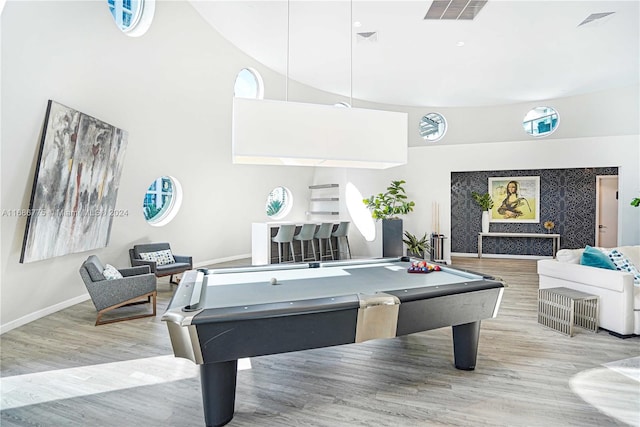 playroom with high vaulted ceiling, pool table, and light hardwood / wood-style flooring