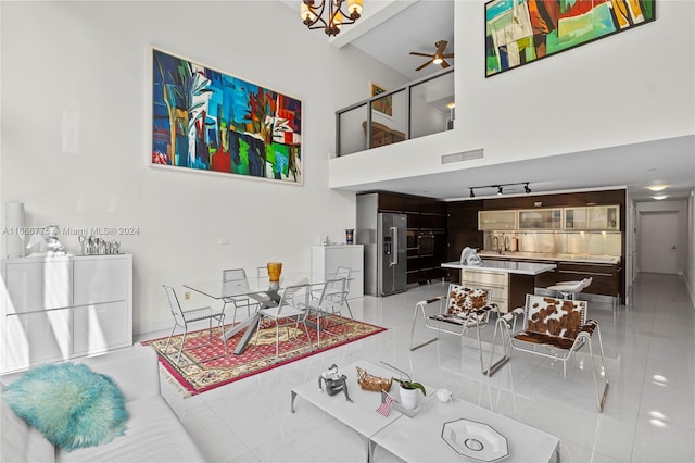 living room with light tile patterned floors and ceiling fan