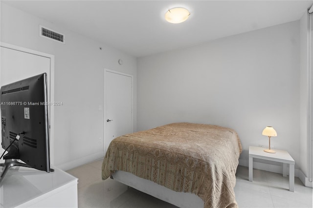 bedroom featuring light tile patterned flooring