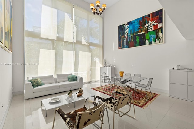 living room with a notable chandelier and light tile patterned floors