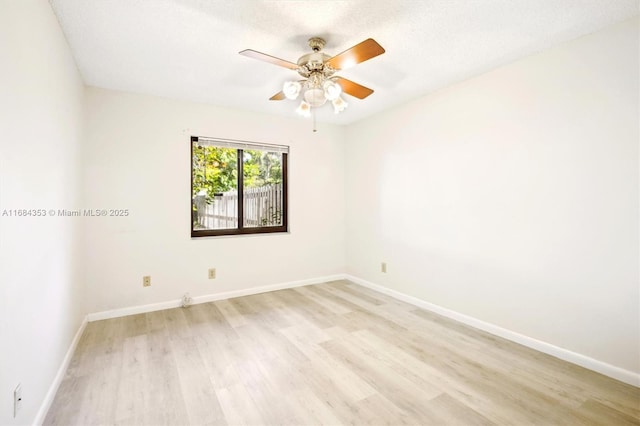 spare room with ceiling fan, a textured ceiling, and light hardwood / wood-style flooring