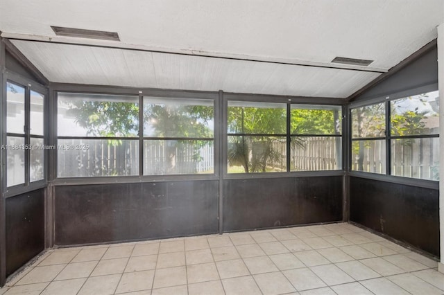 unfurnished sunroom featuring vaulted ceiling