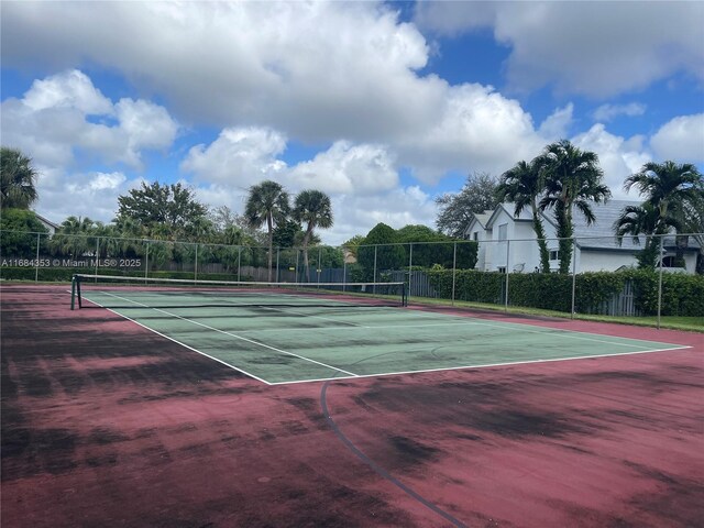 view of tennis court featuring fence