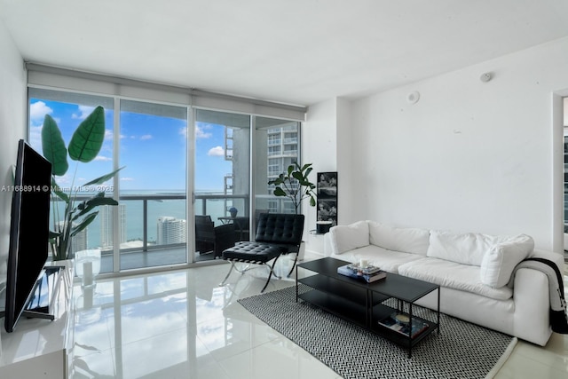 tiled living room with a water view and a wall of windows