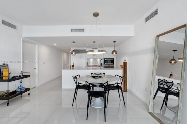 dining room with light tile patterned flooring and sink