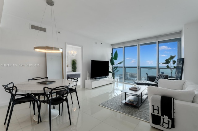 tiled living room with floor to ceiling windows