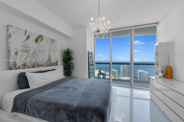 tiled bedroom with multiple windows, access to exterior, expansive windows, and a water view