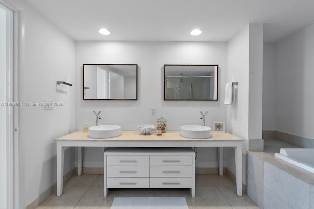 bathroom with tile patterned flooring, vanity, and plus walk in shower