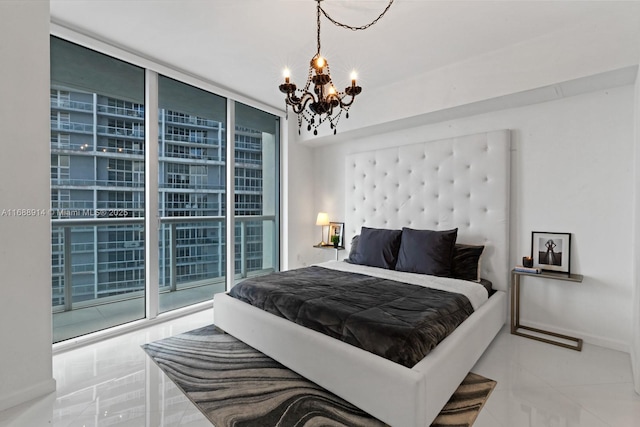 bedroom featuring a chandelier, access to exterior, and a wall of windows