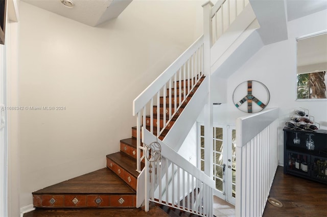 stairway with hardwood / wood-style floors