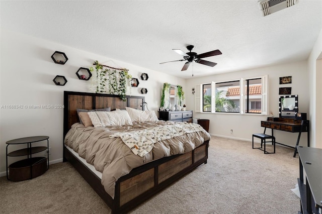 carpeted bedroom with a textured ceiling and ceiling fan