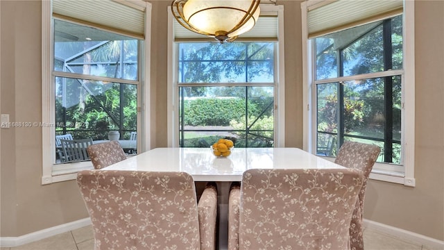 tiled dining space featuring a healthy amount of sunlight