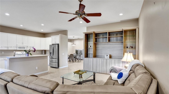 living room featuring ceiling fan and light tile patterned floors