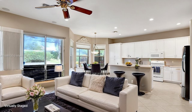 tiled living room featuring ceiling fan