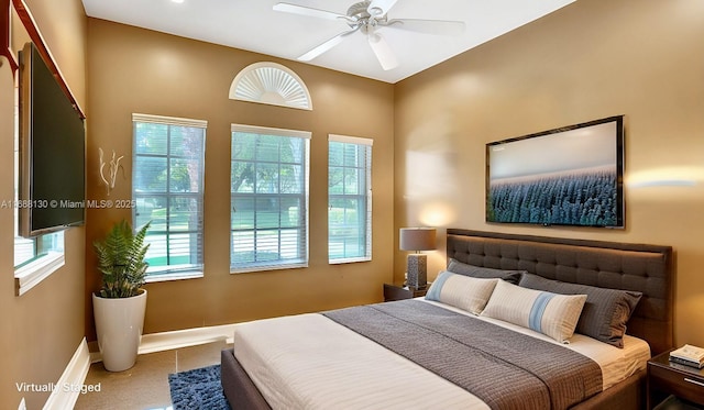 bedroom with tile patterned flooring and ceiling fan