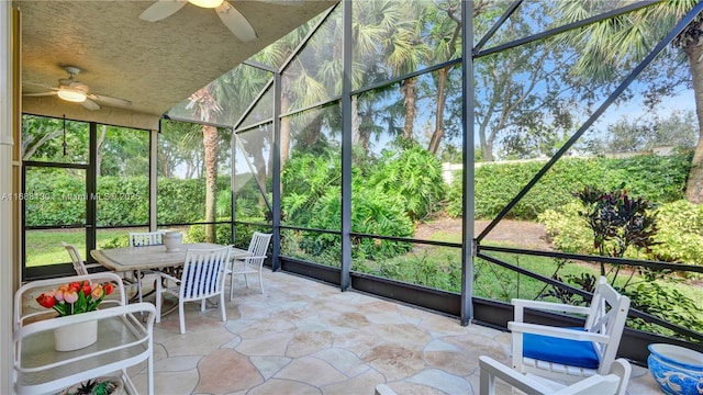 unfurnished sunroom with a wealth of natural light and ceiling fan