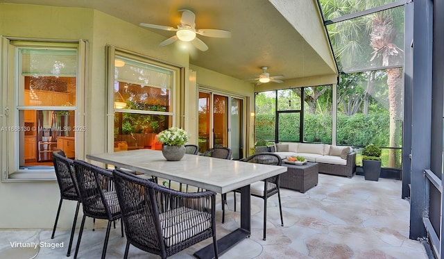 sunroom / solarium featuring ceiling fan