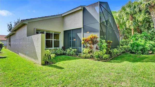 rear view of house featuring a yard