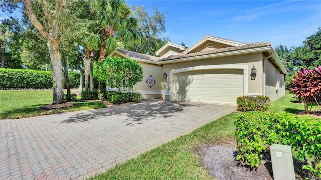 view of front facade with a front yard and a garage