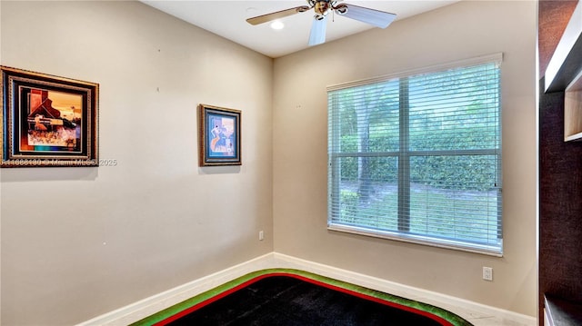 unfurnished room with ceiling fan and a healthy amount of sunlight