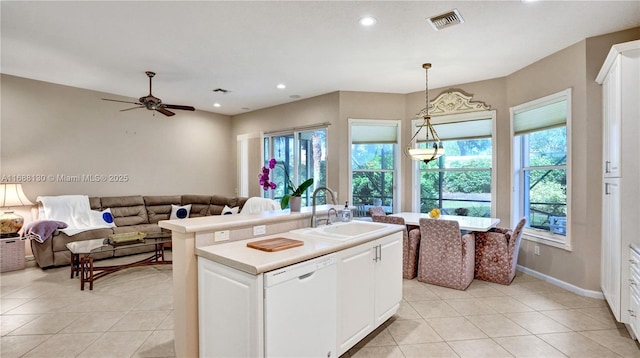 kitchen with white cabinetry, dishwasher, sink, an island with sink, and pendant lighting