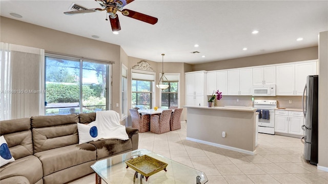 living room with ceiling fan and light tile patterned flooring