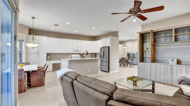 living room with ceiling fan and light tile patterned flooring