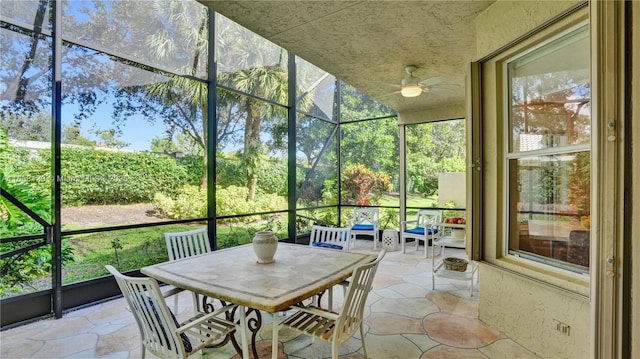 sunroom featuring ceiling fan