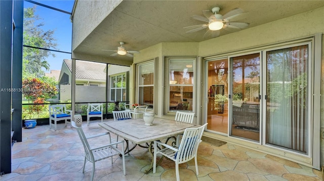 unfurnished sunroom featuring ceiling fan