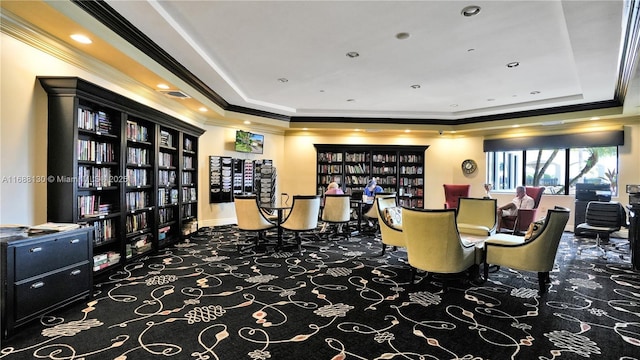 interior space with a tray ceiling and ornamental molding