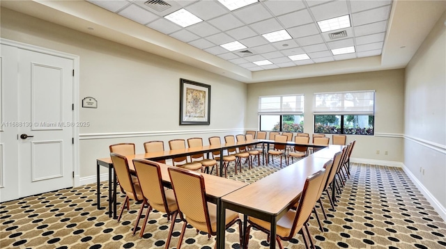 dining room with a drop ceiling