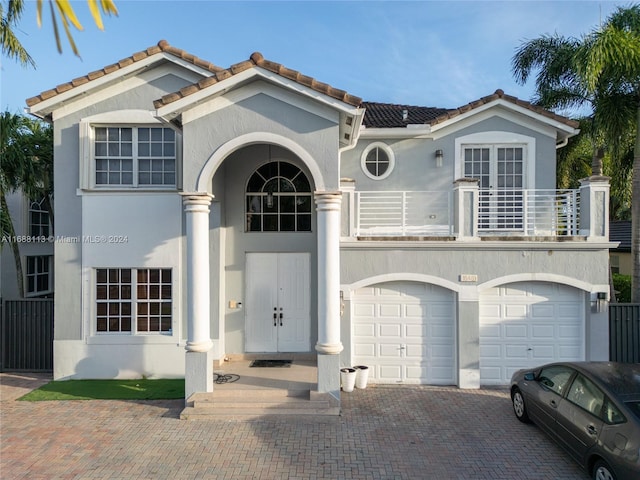 view of front of property featuring a balcony and a garage