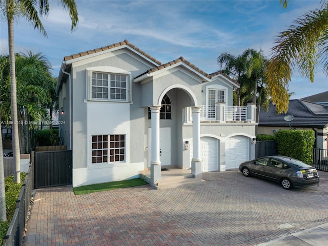 mediterranean / spanish-style home featuring a balcony and a garage