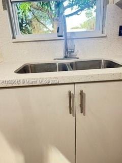 details with white cabinets and sink