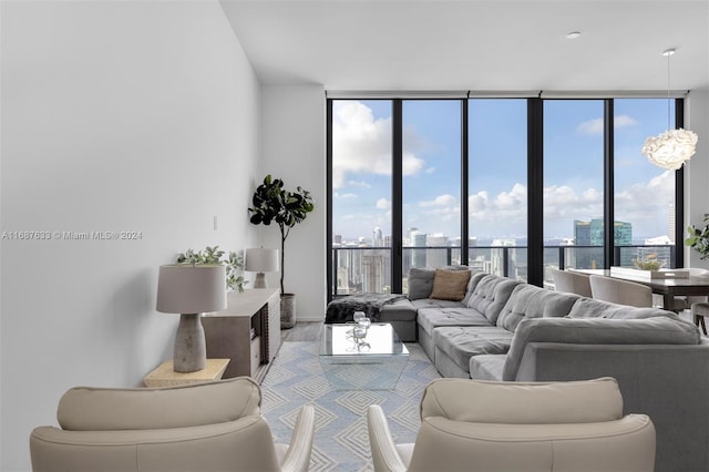 living room featuring floor to ceiling windows, a healthy amount of sunlight, and light hardwood / wood-style floors