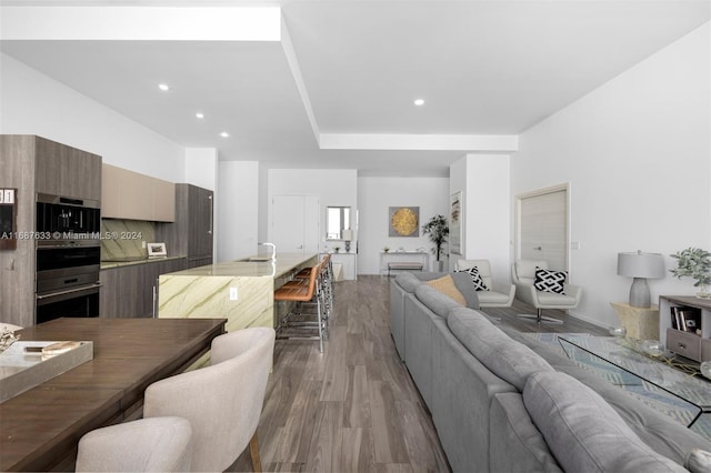 living room with light hardwood / wood-style flooring and sink