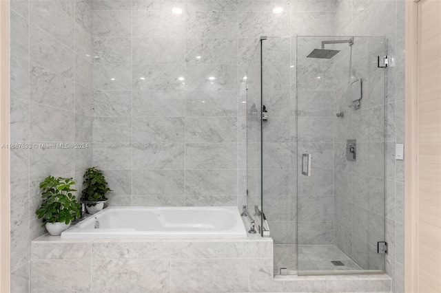 bathroom featuring separate shower and tub