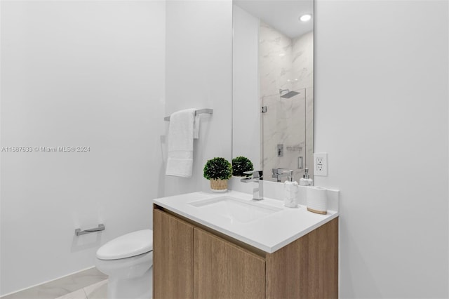 bathroom with tile patterned floors, vanity, toilet, and a shower with door