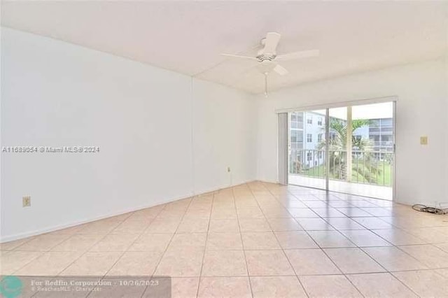 unfurnished room with light tile patterned floors and ceiling fan