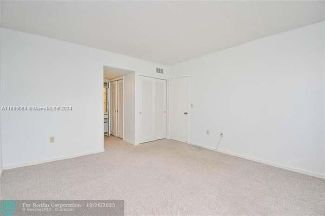 empty room featuring light colored carpet