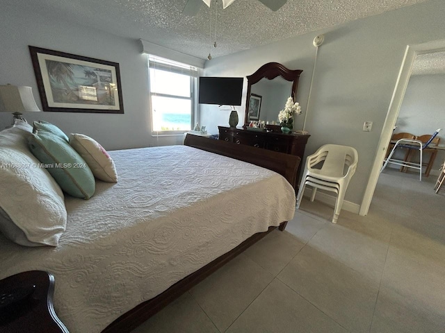 bedroom featuring a textured ceiling and ceiling fan