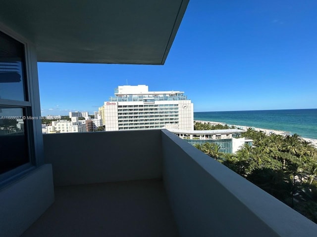 balcony with a view of the beach and a water view