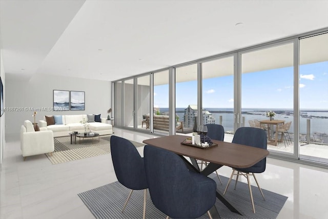 dining area featuring a water view and floor to ceiling windows