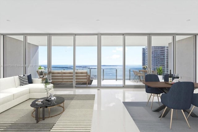 living room with expansive windows and a water view