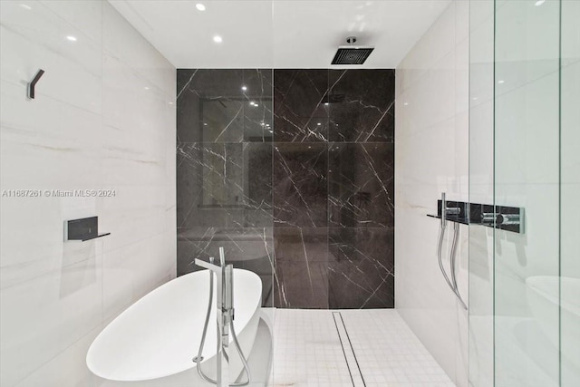 bathroom featuring independent shower and bath and tile walls