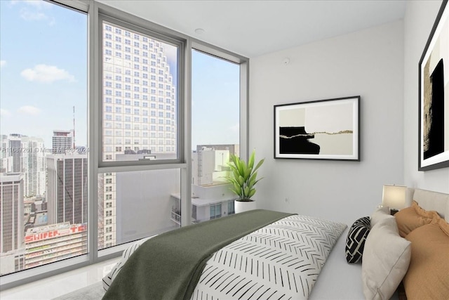 bedroom featuring multiple windows and a wall of windows