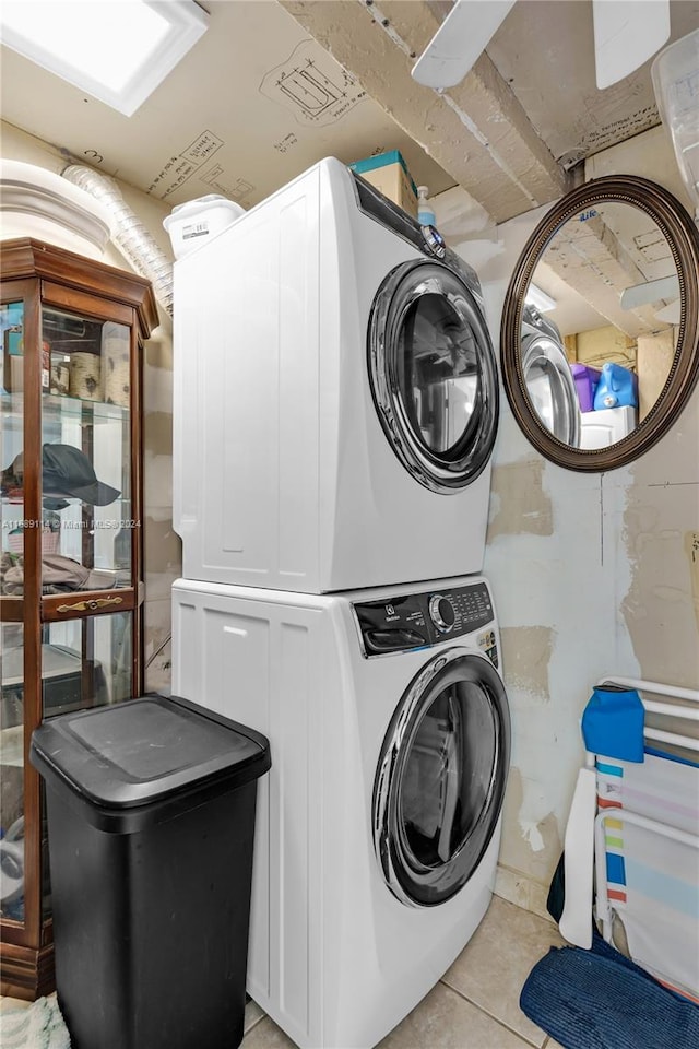 clothes washing area with stacked washer and dryer