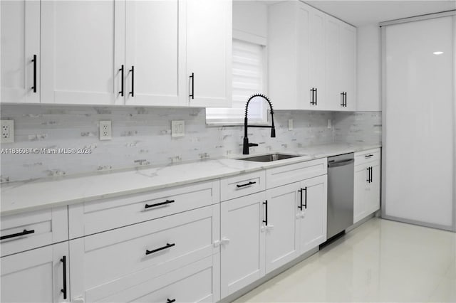 kitchen featuring light stone countertops, white cabinetry, sink, and dishwasher