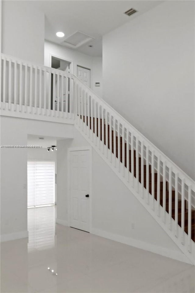 stairway with concrete flooring